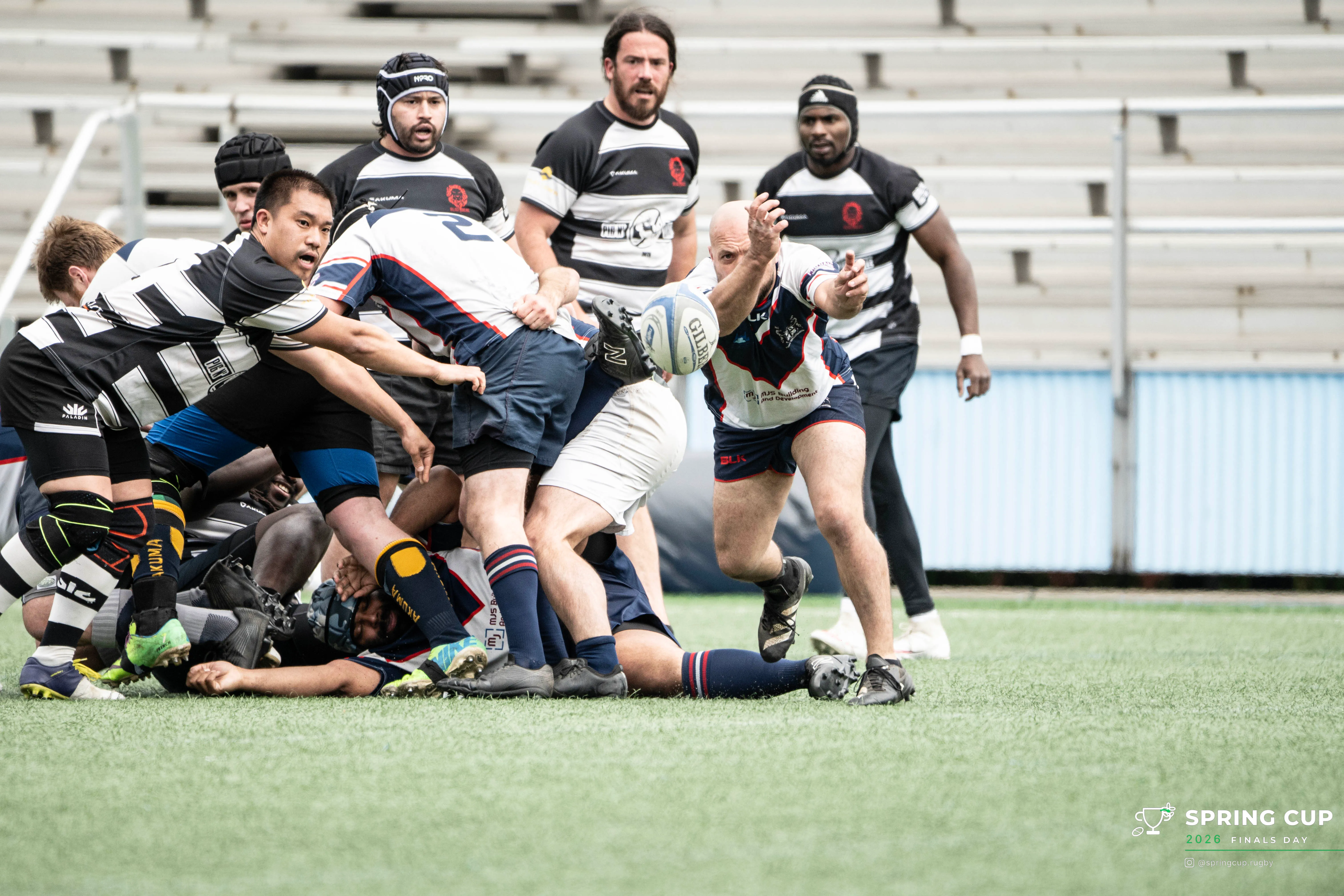 A scrum-half clears the ball from the base of a ruck