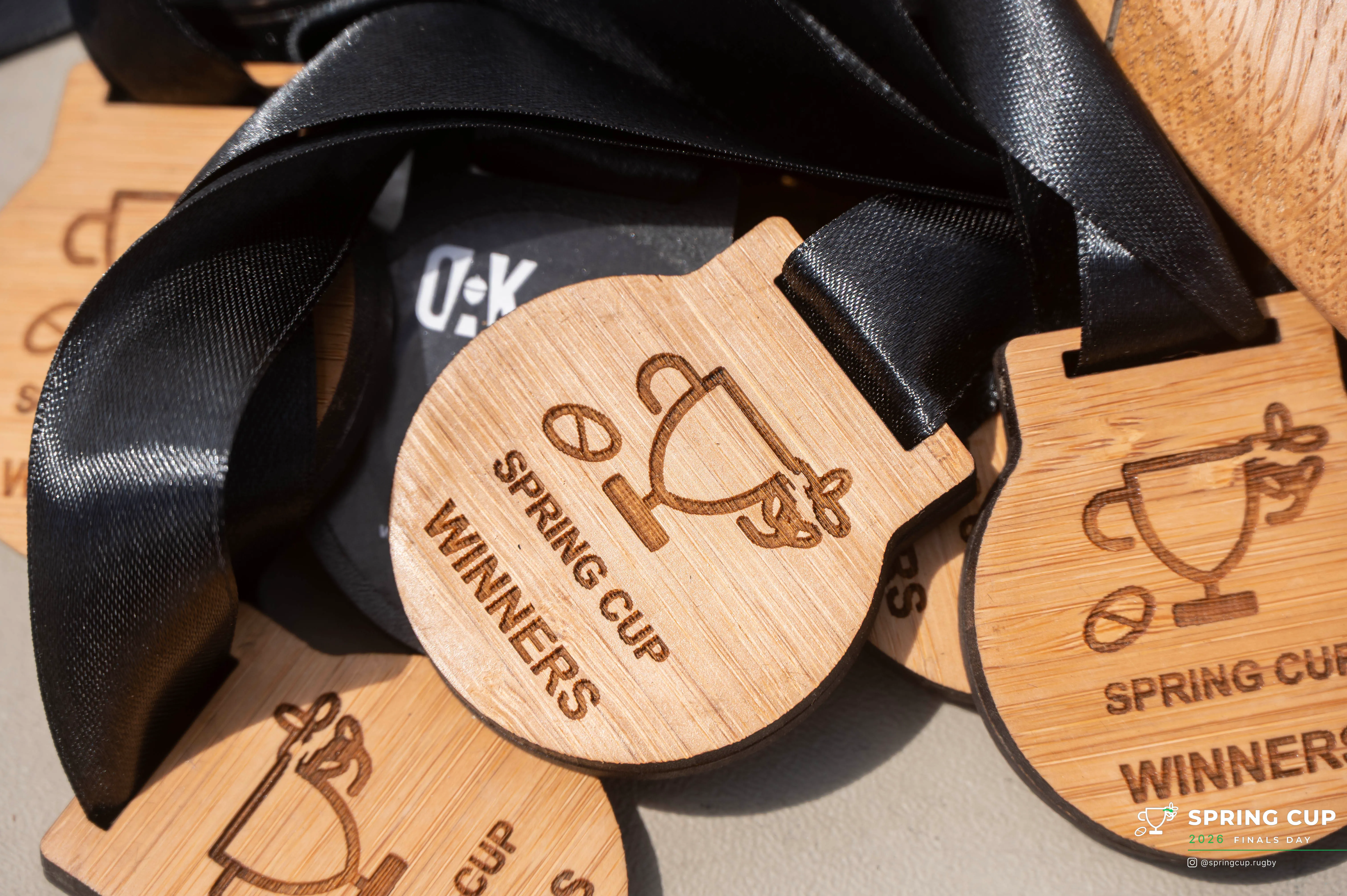 Close-up of the hand-crafted wooden Spring Cup winners medals by Oak & Black
